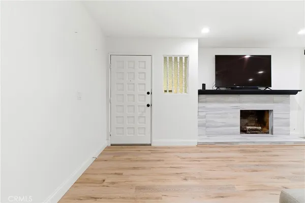 a living room with a fireplace and a flat screen tv