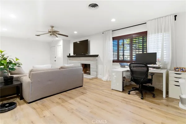 a living room with furniture a fireplace and a flat screen tv