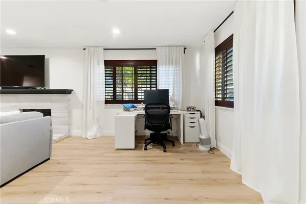 a view of a livingroom with workspace and a window