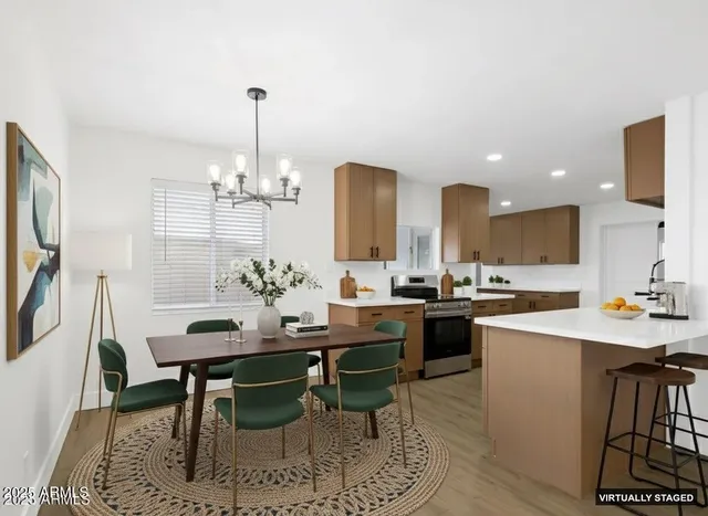 a kitchen with a dining table chairs sink and stove