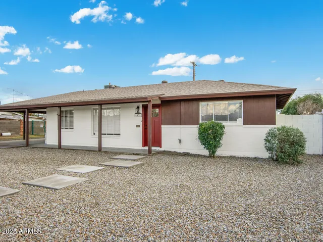 a front view of a house with plants