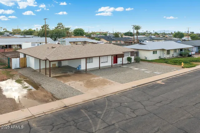 an aerial view of a house with a yard and lake view