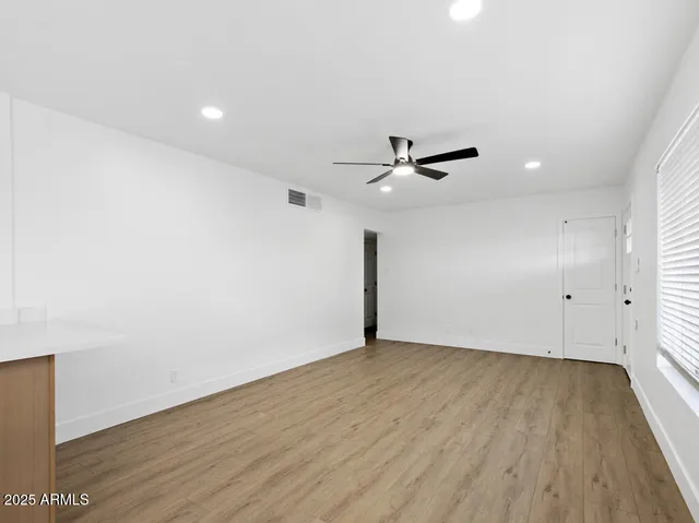 wooden floor in an empty room with a window