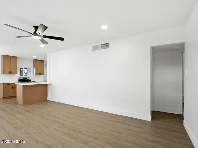 a view of a kitchen with wooden floor and a sink