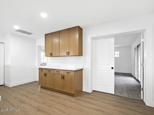 a kitchen with a sink and wooden floor