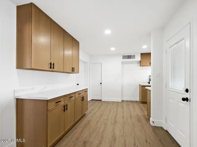 a view of empty room with wooden floor