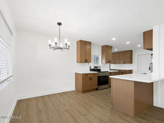 a kitchen with a sink and a stove top oven