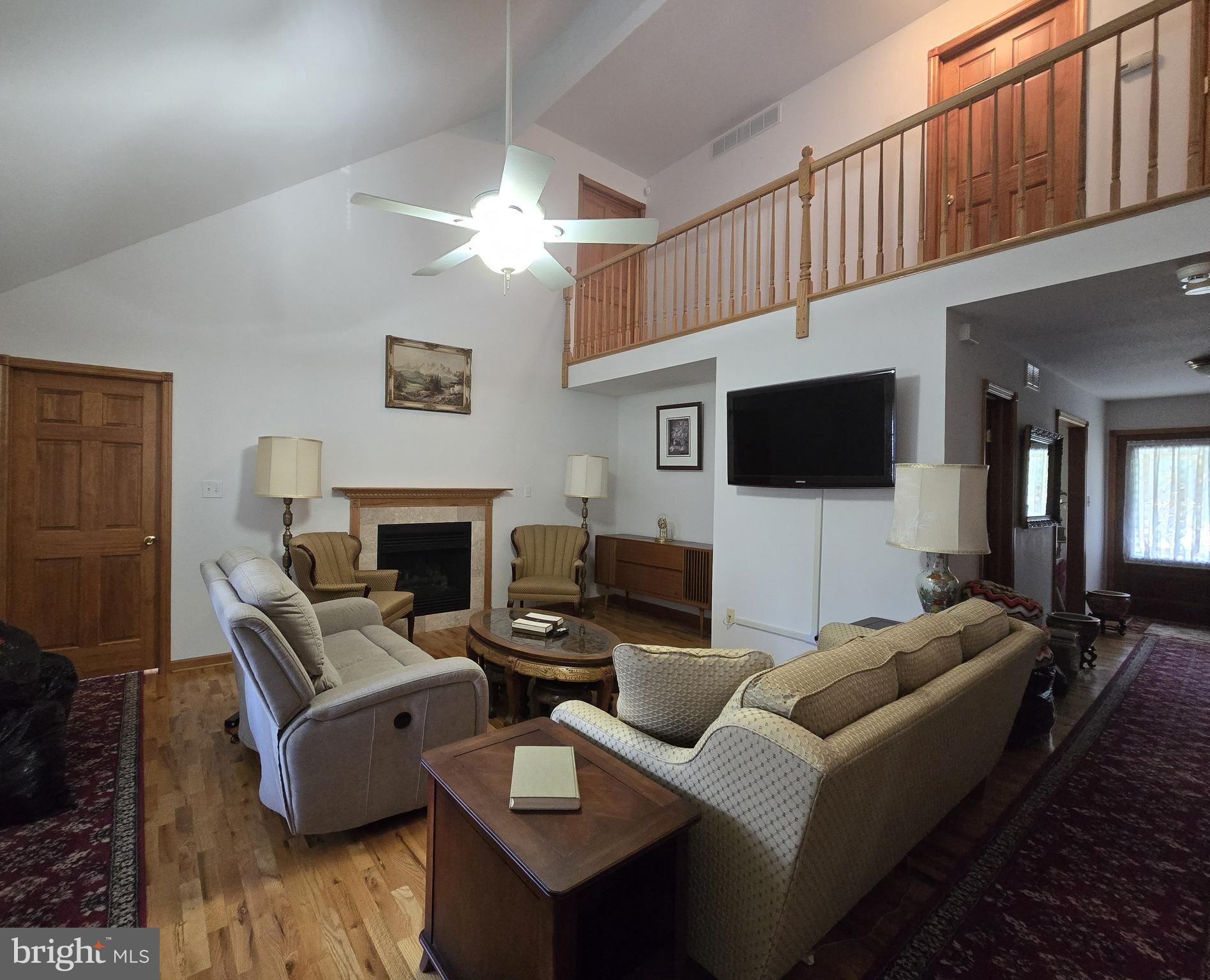 135 Trenton Road Browns Mills, NJ 08015 - Photo 14 of 49 a living room with furniture a fireplace and a flat screen tv