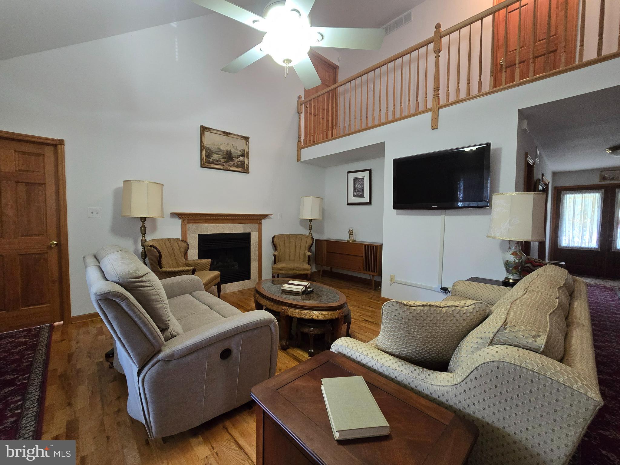 135 Trenton Road Browns Mills, NJ 08015 - Photo 15 of 49 a living room with furniture a flat screen tv and a fireplace