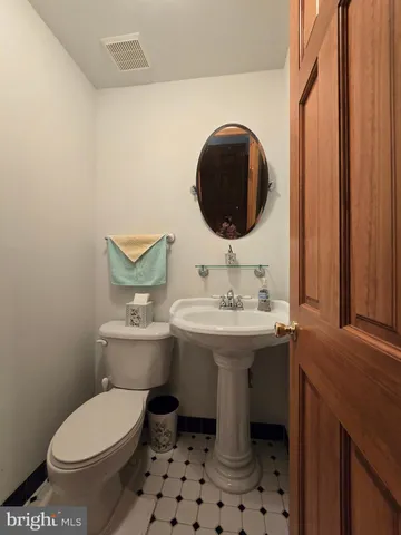 a bathroom with a sink toilet and mirror