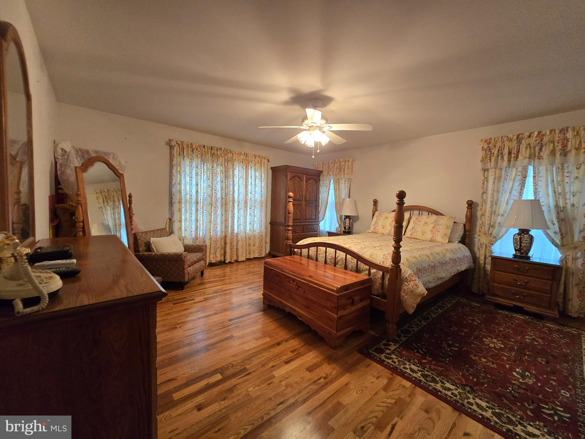 135 Trenton Road Browns Mills, NJ 08015 - Photo 22 of 49 a spacious bedroom with a bed a chandelier and dresser