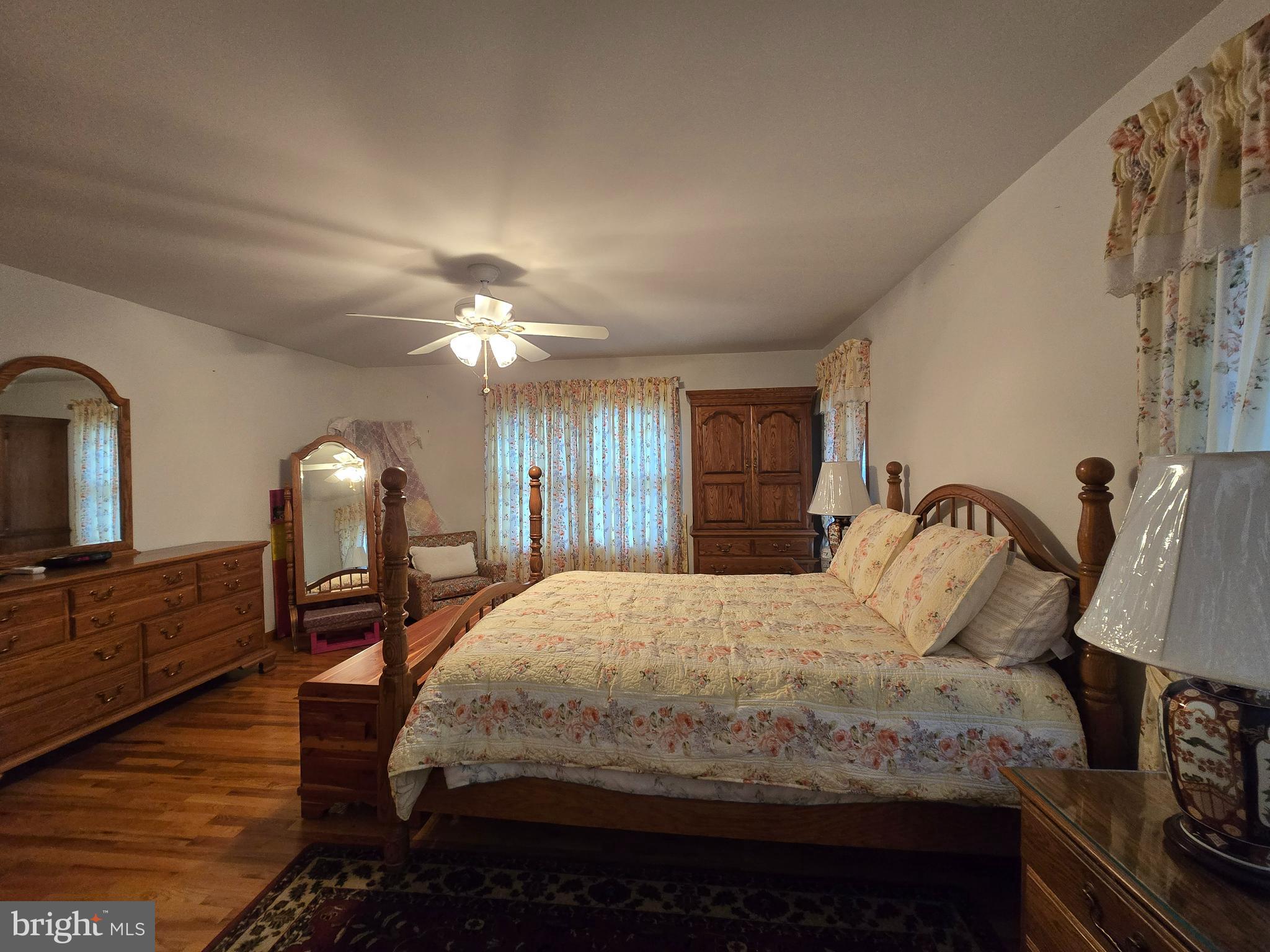 135 Trenton Road Browns Mills, NJ 08015 - Photo 23 of 49 a bedroom with a bed and a chandelier