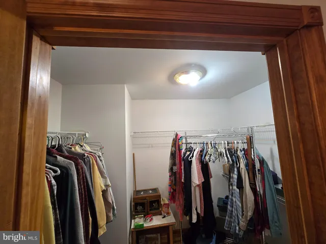a view of walk in closet with clothes