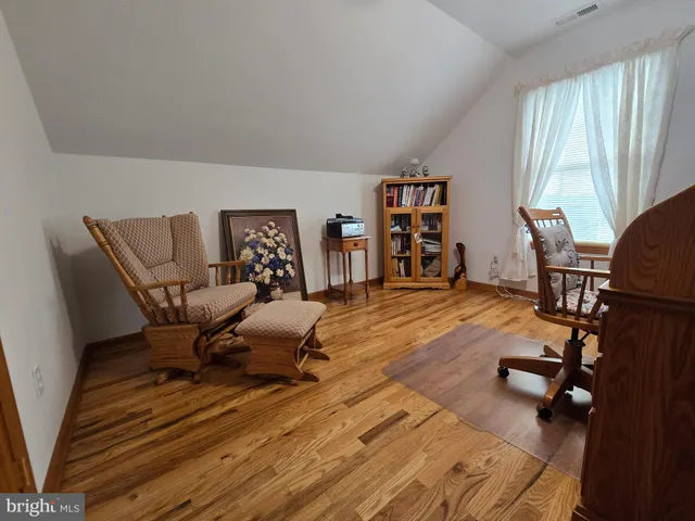 a bedroom with furniture and a wooden floor
