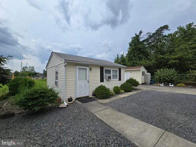 a view of a house with a yard and plants