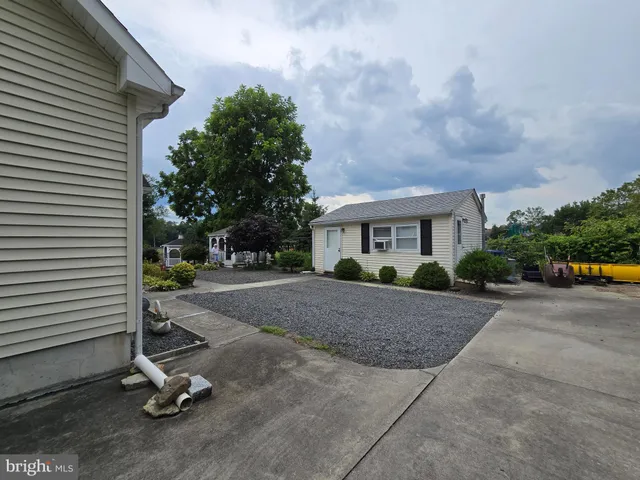 a view of a white house with a patio