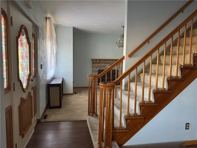a view of an empty room with a fireplace and a window