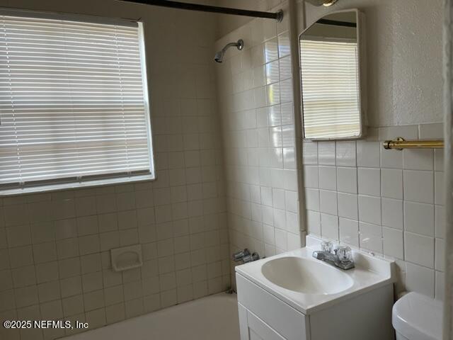2918 Fitzgerald Street Jacksonville, FL 32254 - Photo 6 of 7 a bathroom with a sink a toilet and a mirror