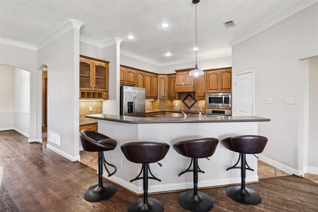 120 Waldrum Road Combine, TX 75159 - Photo 12 of 35 a kitchen with stainless steel appliances granite countertop a counter space and a refrigerator