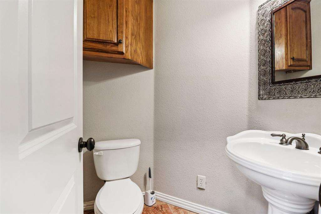 120 Waldrum Road Combine, TX 75159 - Photo 15 of 35 a bathroom with a toilet sink and mirror