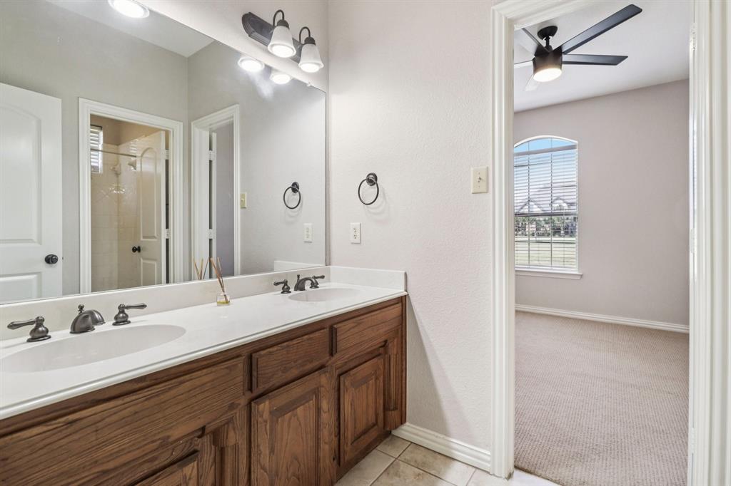 120 Waldrum Road Combine, TX 75159 - Photo 20 of 35 a bathroom with a double vanity sink a mirror and a shower