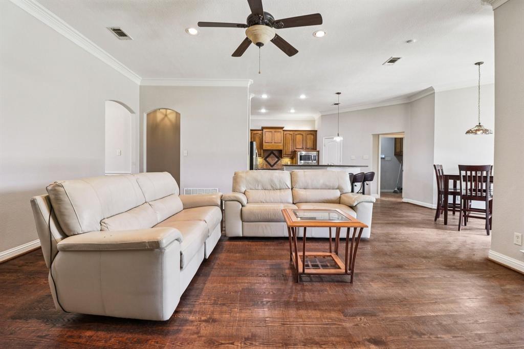 120 Waldrum Road Combine, TX 75159 - Photo 9 of 35 a living room with furniture and a dining table with wooden floor