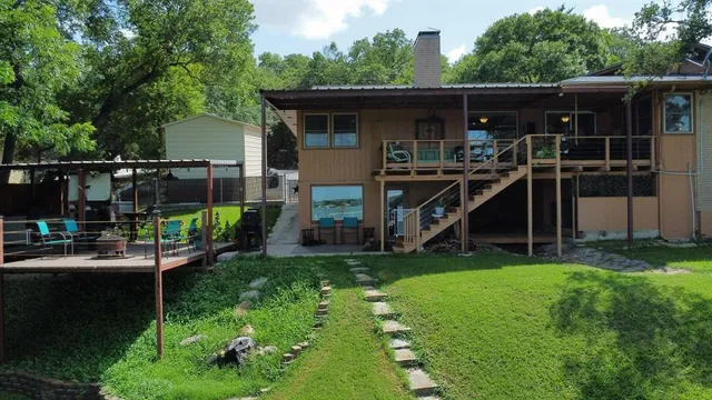 a view of house and yard with swimming pool