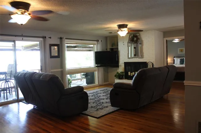 a living room with furniture a fireplace and a flat screen tv