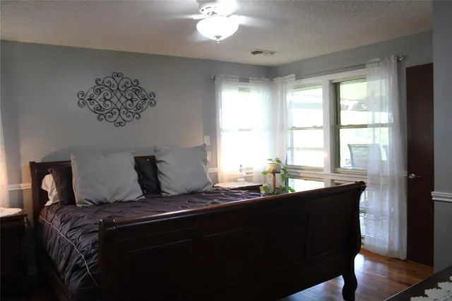 a bedroom with a large bed and a window