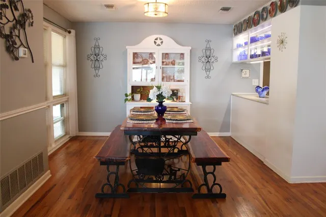 a view of a dining room with furniture and wooden floor