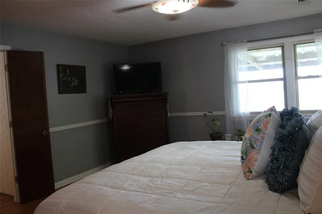 a bed sitting in a bedroom next to a window