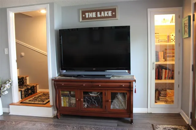 a living room with a fireplace and a flat screen tv
