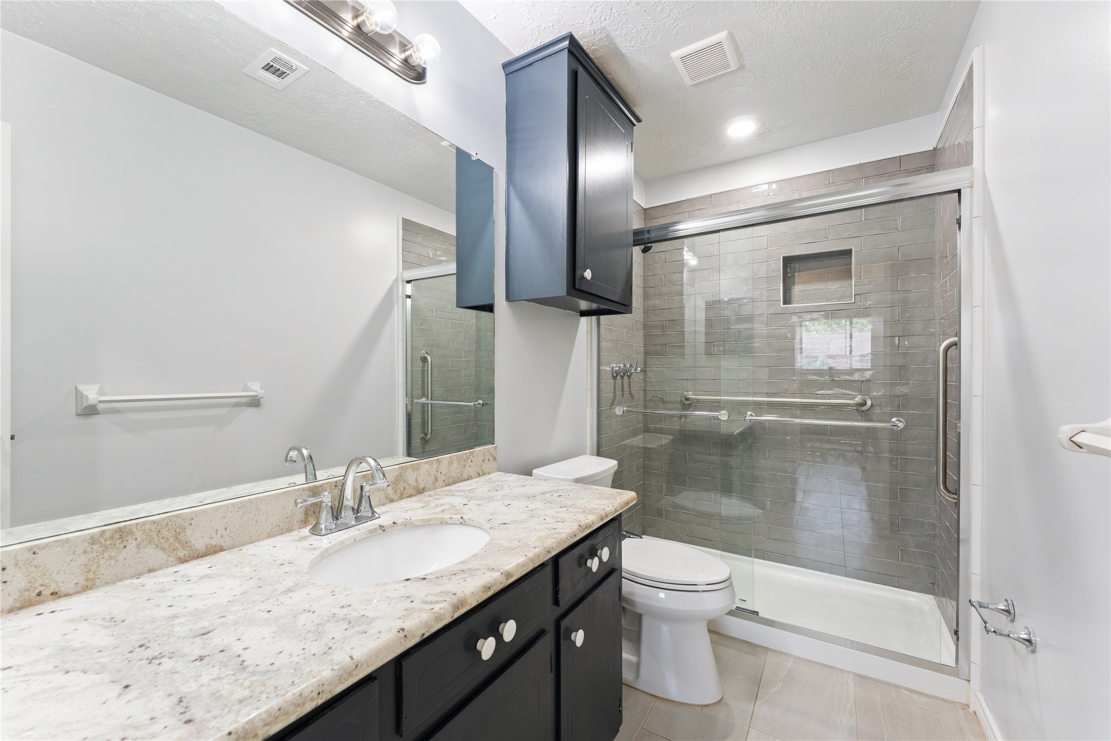 1431 Epsilon Street Pasadena, TX 77504 - Photo 19 of 21 a bathroom with a granite countertop sink a toilet and shower