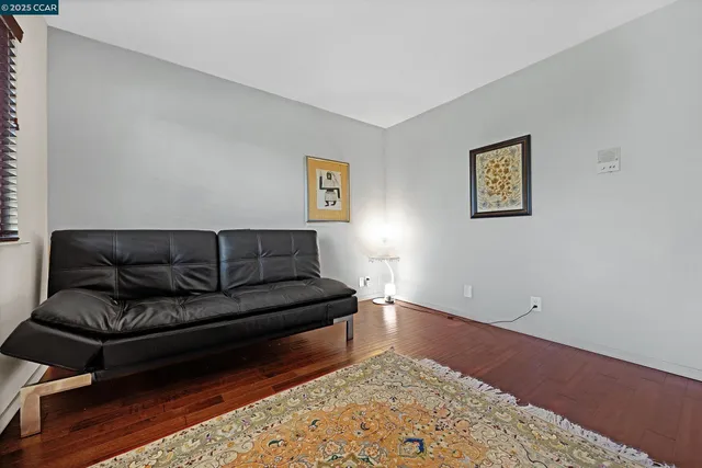 a living room with furniture large windows and a fireplace