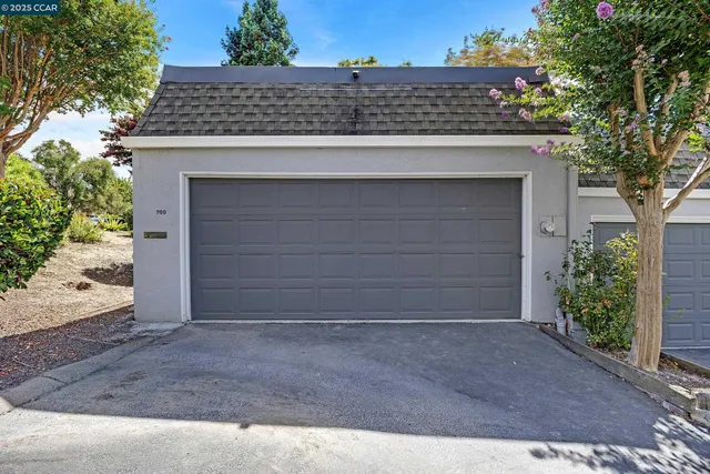 a bedroom with a bed and a lamp on dresser