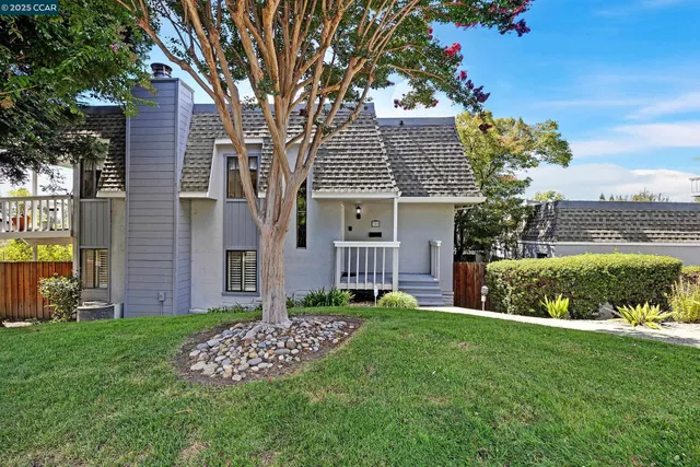 a view of a porch with chairs and backyard