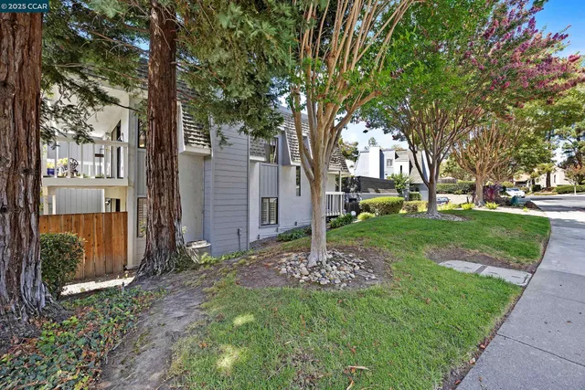 a kitchen with stainless steel appliances kitchen island granite countertop a refrigerator a stove and a sink