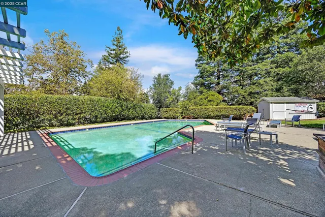 a view of a house with a yard and potted plants