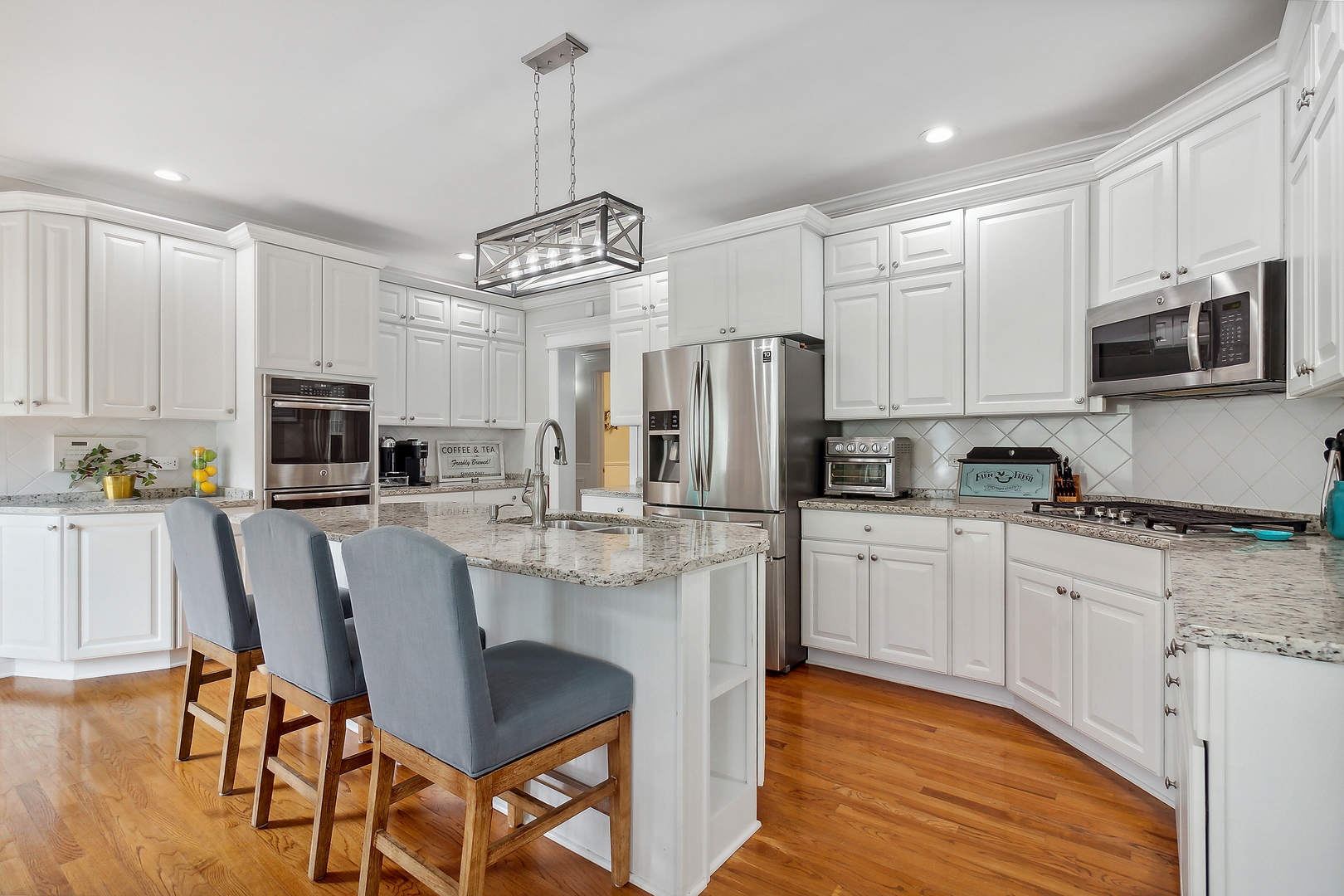 2252 Joyce Lane Naperville, IL 60564 - Photo 5 of 33 a kitchen with stainless steel appliances granite countertop a stove top oven a refrigerator a sink and a dining table with wooden floor
