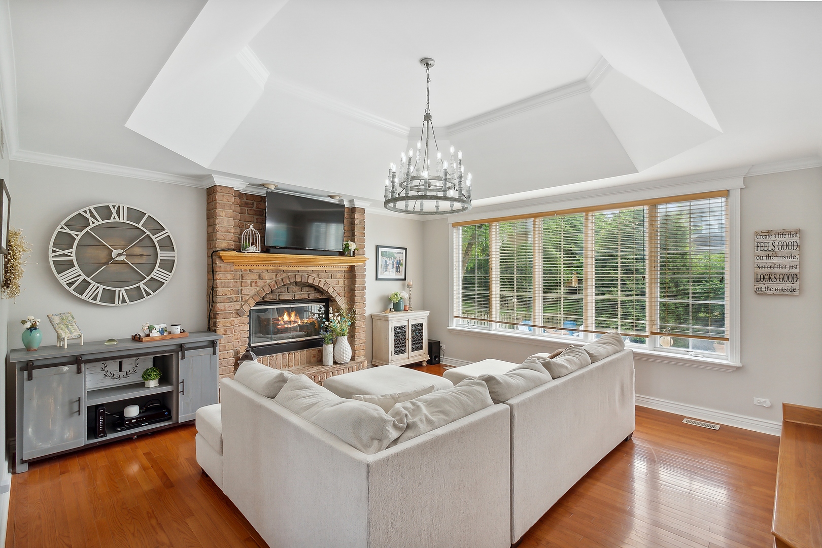 2252 Joyce Lane Naperville, IL 60564 - Photo 9 of 33 a living room with furniture a fireplace and a chandelier