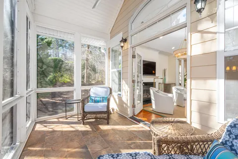 a living room with patio furniture and a fireplace