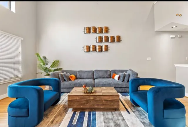 a living room with furniture and a potted plant