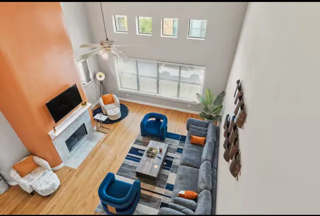 a living room with furniture and a floor to ceiling window