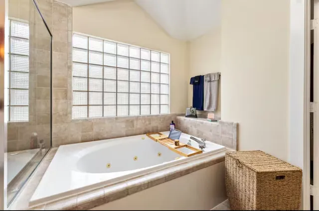 a bathroom with a bathtub and a window