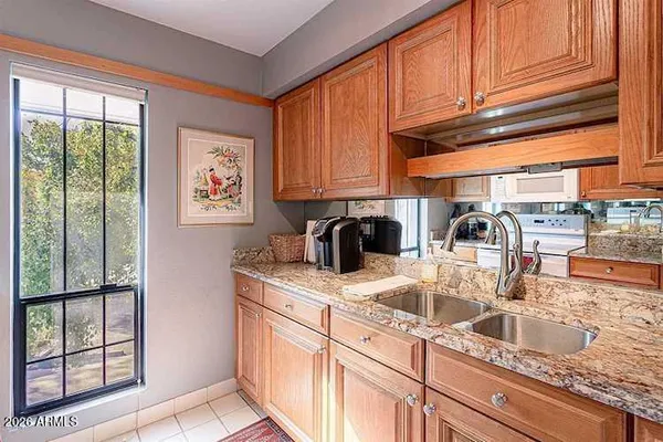 a kitchen with a sink a stove and cabinets