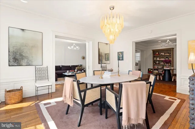 a view of a dining room with furniture and a chandelier