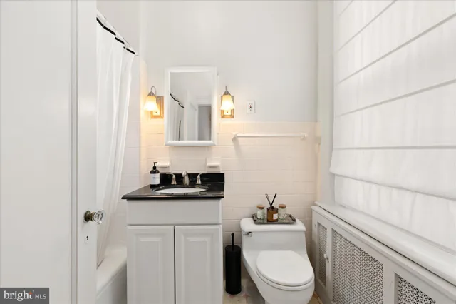 a bathroom with a toilet a sink and a mirror