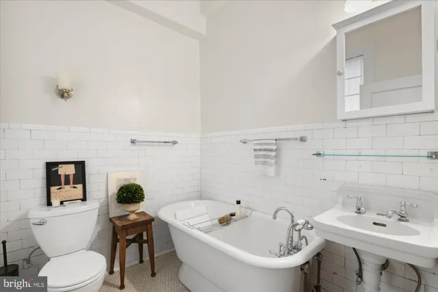 a white toilet sitting next to a bathroom sink