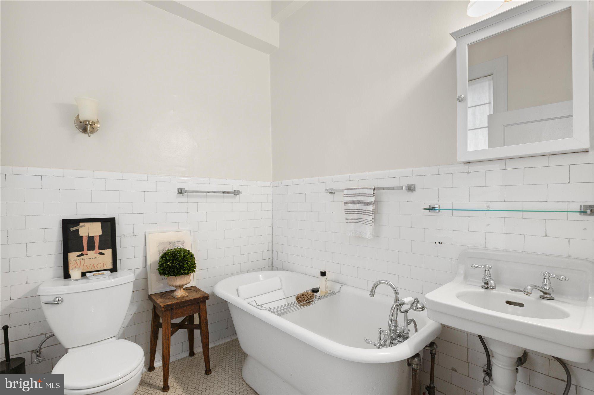 2029 Connecticut Avenue Northwest, Unit 42 Washington, DC 20008 - Photo 28 of 37 a white toilet sitting next to a bathroom sink