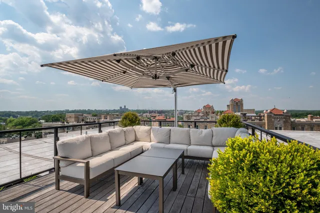 a roof deck with a table and chairs